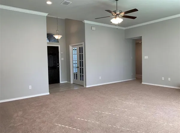 a view of an empty room with a ceiling fan