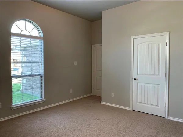 an empty room with windows mirror and windows