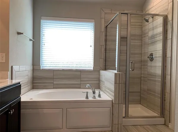 a bathroom with a shower and a sink