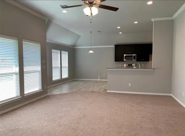a view of a livingroom with a piano and a flat screen tv