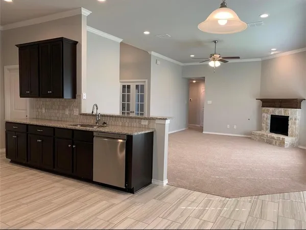 a kitchen with stainless steel appliances granite countertop a sink and a stove