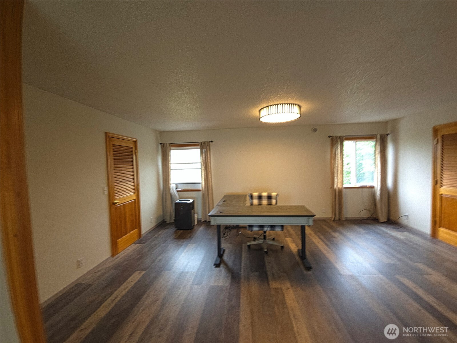 240 Stringtown Road Ilwaco, WA 98624 - Photo 14 of 39 a view of a livingroom with furniture window and wooden floor