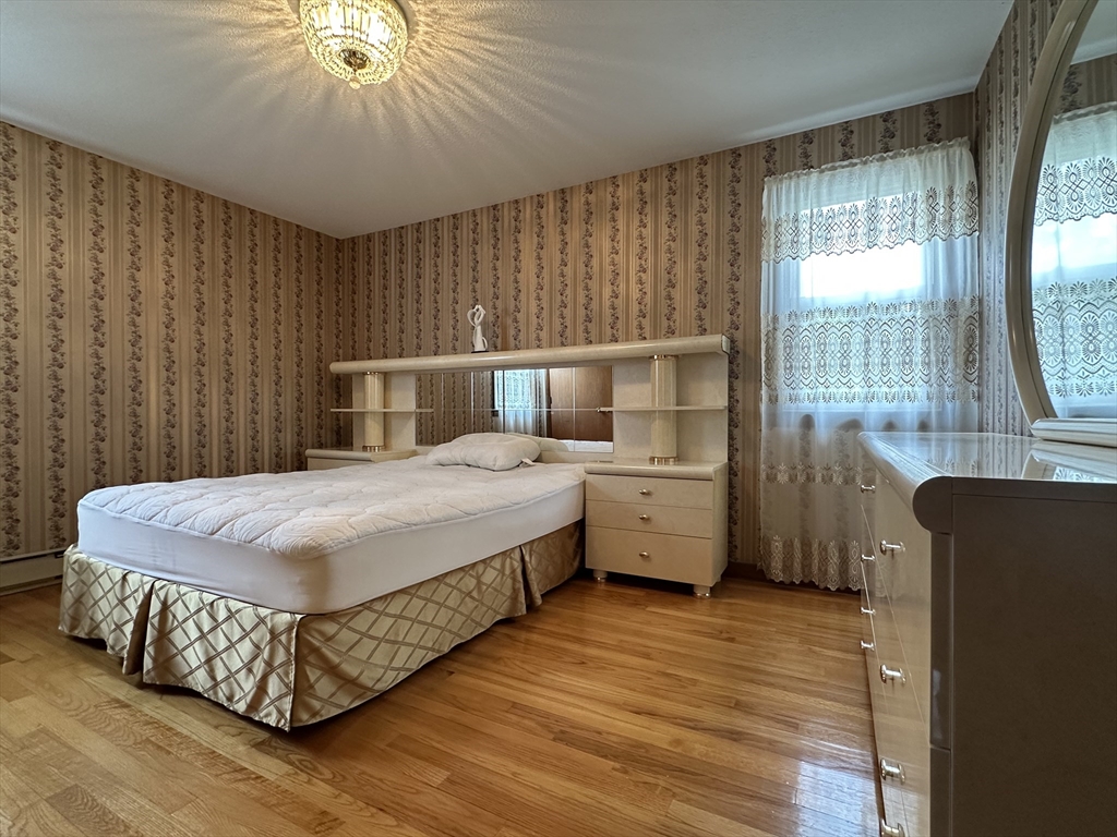 18 Crystal Brook Drive Springfield, MA 01118 - Photo 13 of 20 a bedroom with a bed and wooden floor