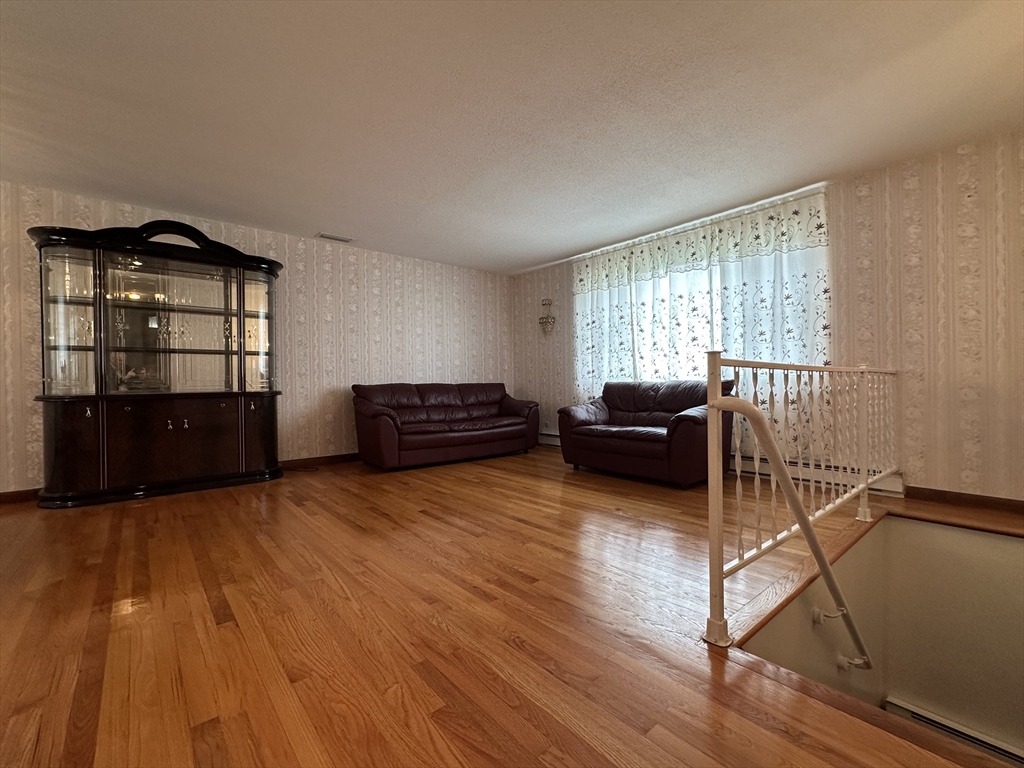 18 Crystal Brook Drive Springfield, MA 01118 - Photo 7 of 20 a living room with furniture and a flat screen tv