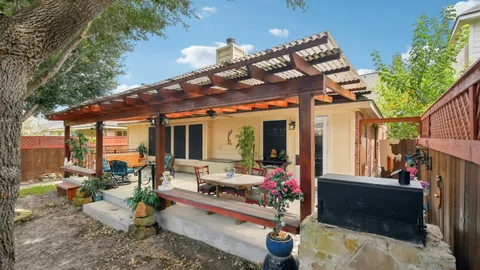 a view of a chairs and tables in patio of back yard of the house