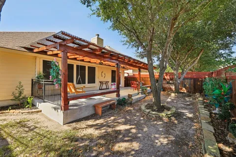 a view of a house with backyard and sitting area