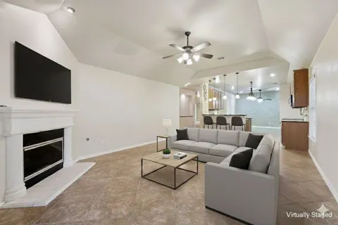 a living room with furniture a fireplace and a flat screen tv