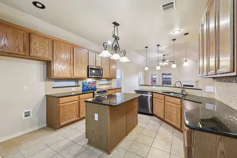 a kitchen with stainless steel appliances granite countertop a sink counter space cabinets and stainless steel appliances