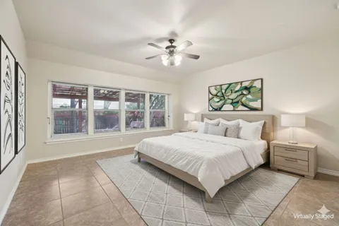 a bedroom with a large bed and a large window