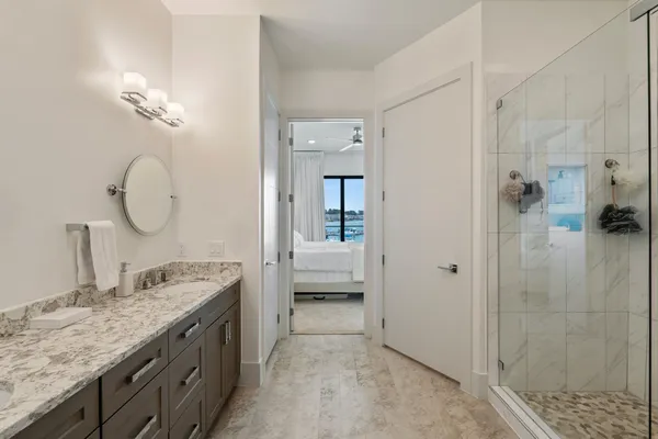 a bedroom with a bed and a painting on the wall