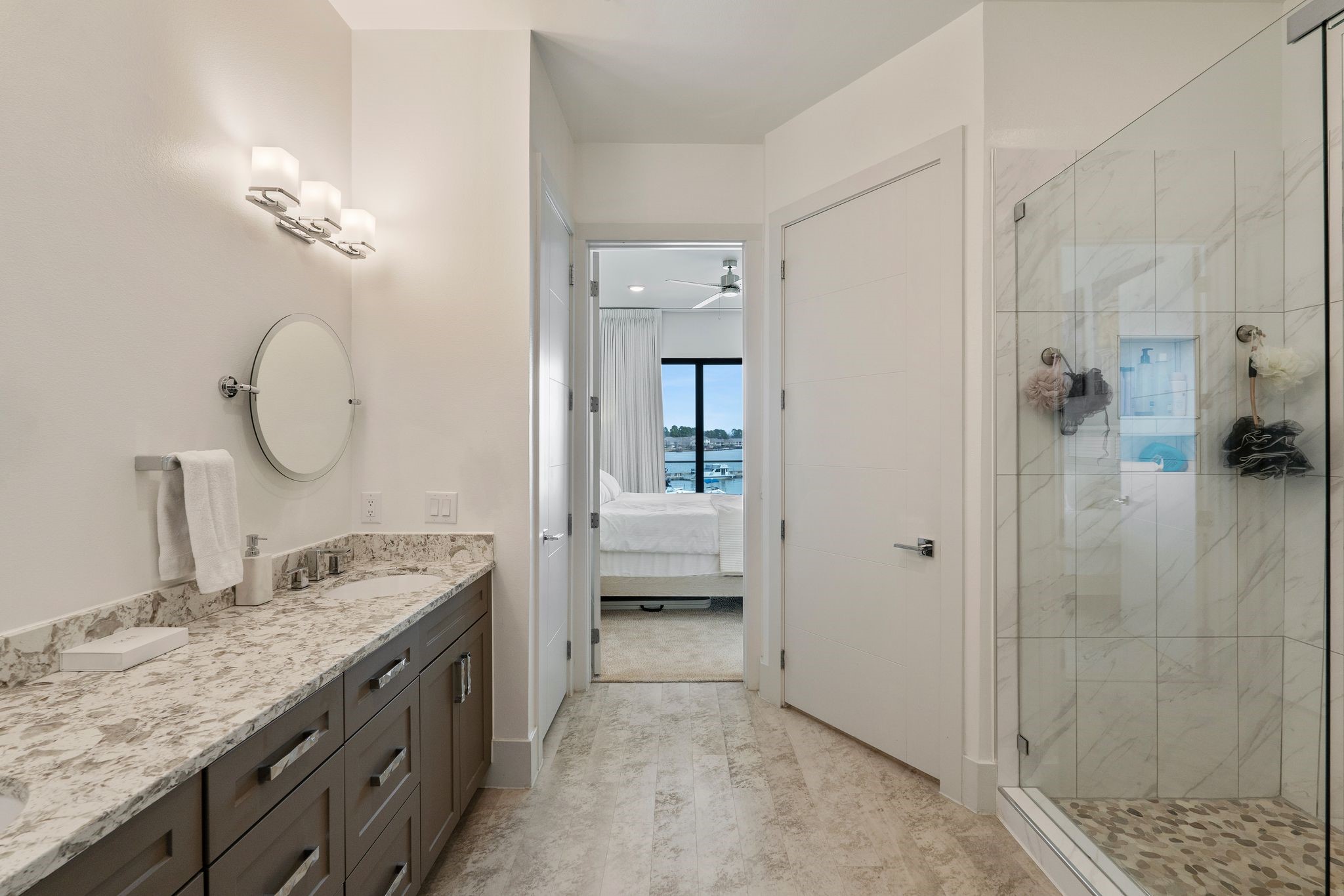 199 Waterpoint Court, Unit 213 Montgomery, TX 77356 - Photo 22 of 46 a bathroom with a granite countertop sink a mirror and shower