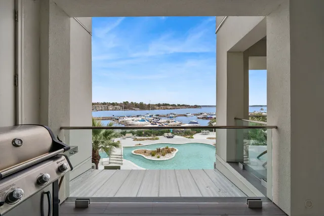 a view of a balcony with dining table and chairs