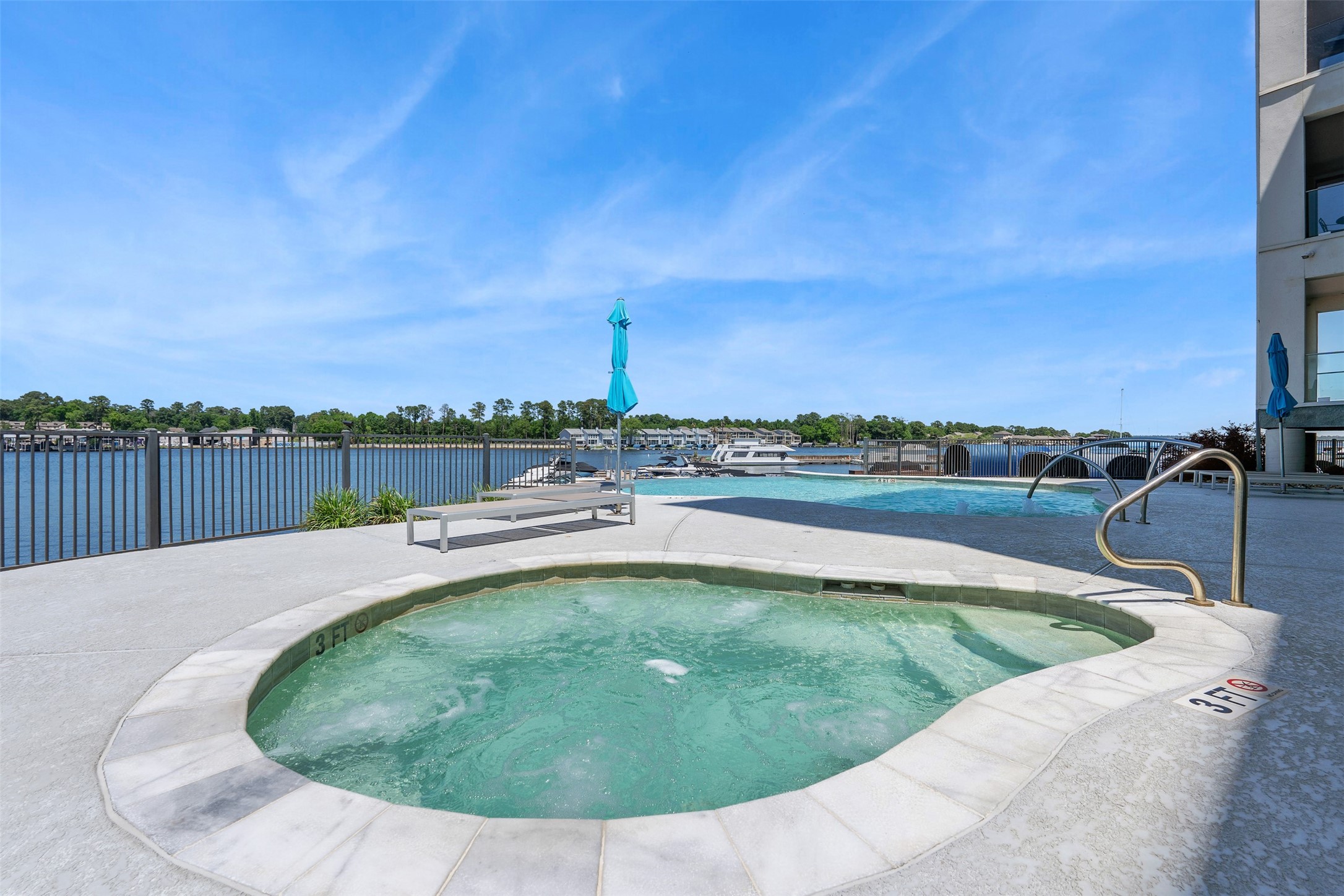 199 Waterpoint Court, Unit 213 Montgomery, TX 77356 - Photo 43 of 46 a view of a swimming pool with a terrace