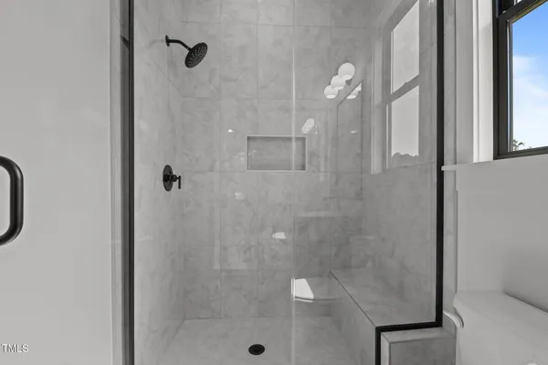 an empty room with a window and a ceiling fan