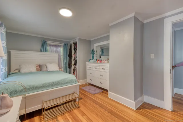 a bedroom with a bed and a dresser
