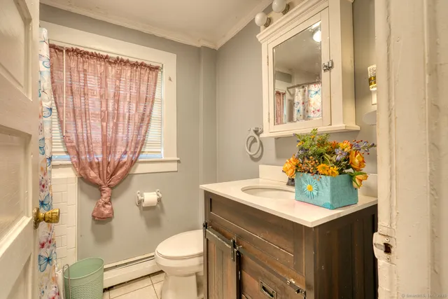 a bathroom with a sink toilet and a mirror