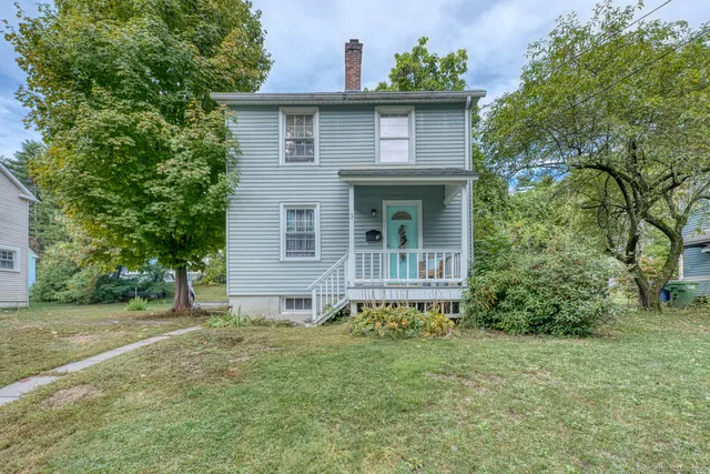 a brick house with trees in front of it