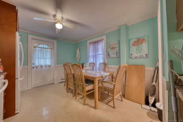 a view of a dining room with furniture and chandelier