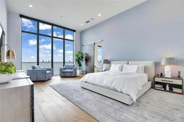 a bedroom with double bed and a large window