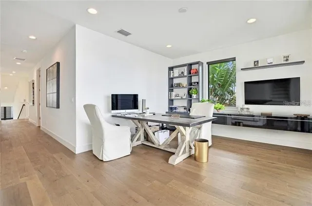 a view of a livingroom with furniture and a flat screen tv
