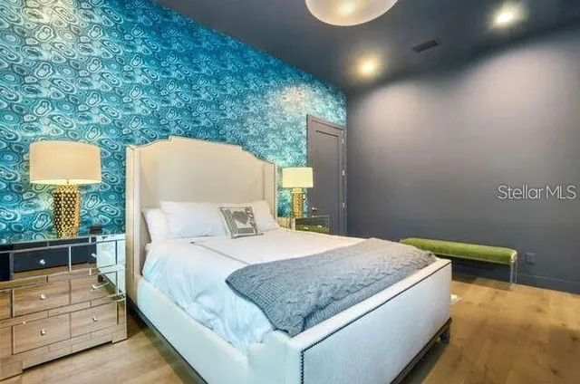 a bedroom with a bed and a lamp