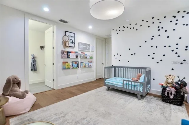 a bedroom with furniture and a wooden floor