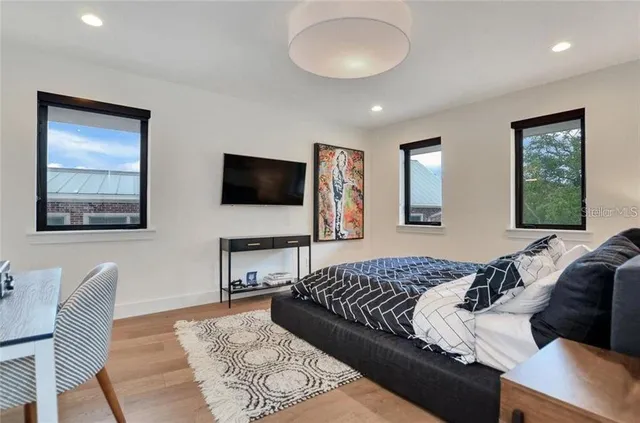 a bedroom with a bed and a flat screen tv