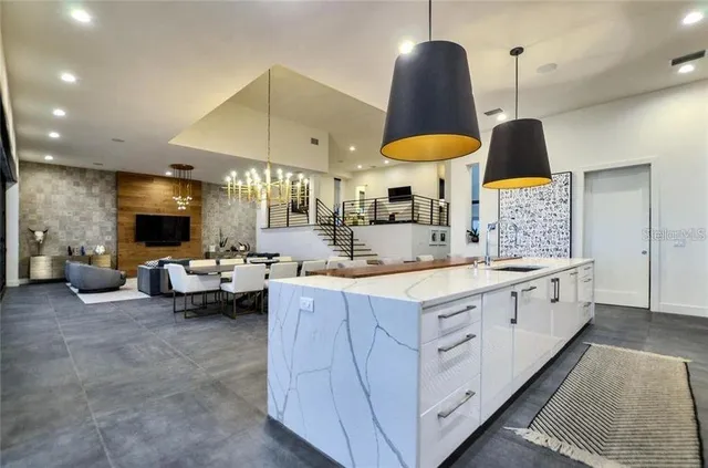 a kitchen with stainless steel appliances lots of counter space and wooden floor