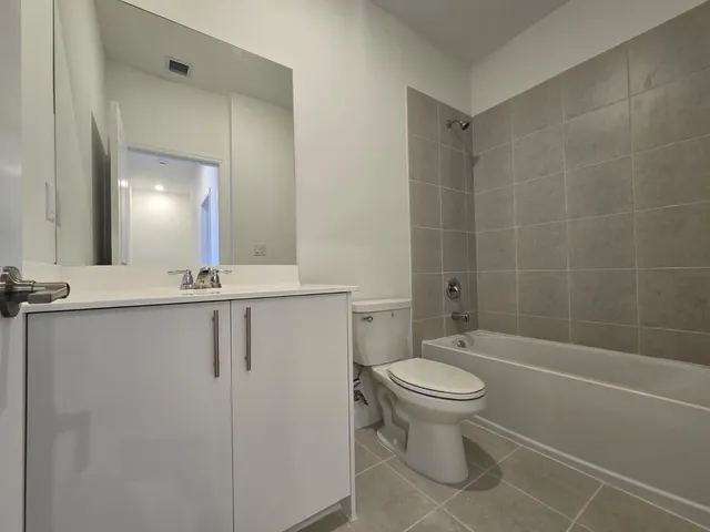 a bathroom with a toilet a sink and bathtub
