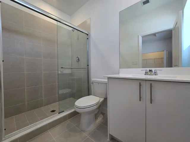 a bathroom with a shower a toilet and sink