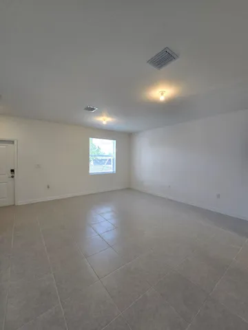 an empty room with a empty space and windows