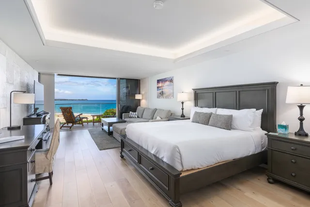 a large bedroom with a bed and large window