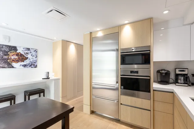 a kitchen with a refrigerator and a sink