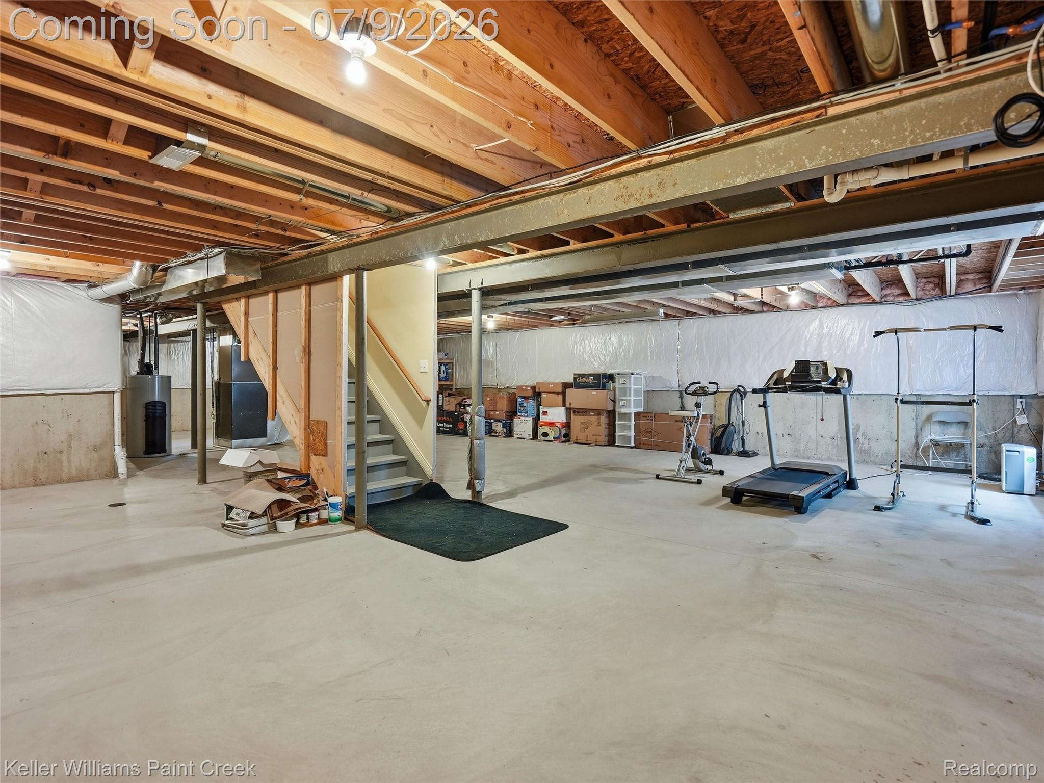 846 Monterey Ln. Rochester, MI 48307 - Photo 33 of 52 Expansive unfinished basement featuring an exposed wood joist ceiling, concrete flooring, and an accessible staircase