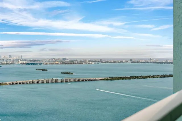 a view of a field with an ocean view