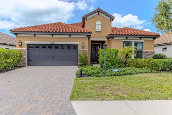 a front view of a house with a yard and garage