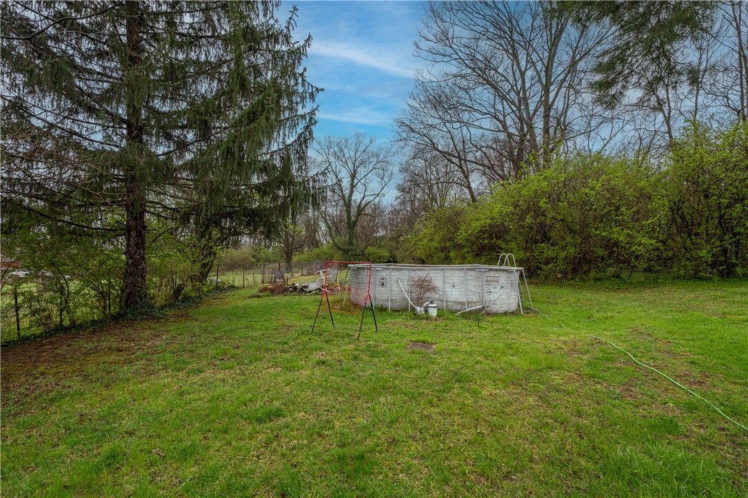 106 Burton Road Middletown, OH 45044 - Photo 6 of 7 This verdant yard offers a delightful above-ground pool, perfect for outdoor recreation and relaxation.