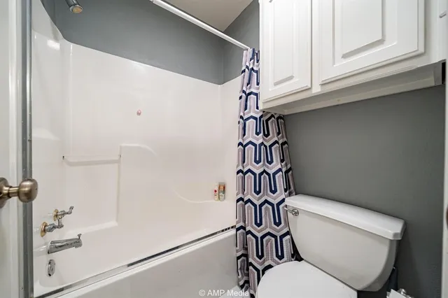 a bathroom with a toilet and a shower