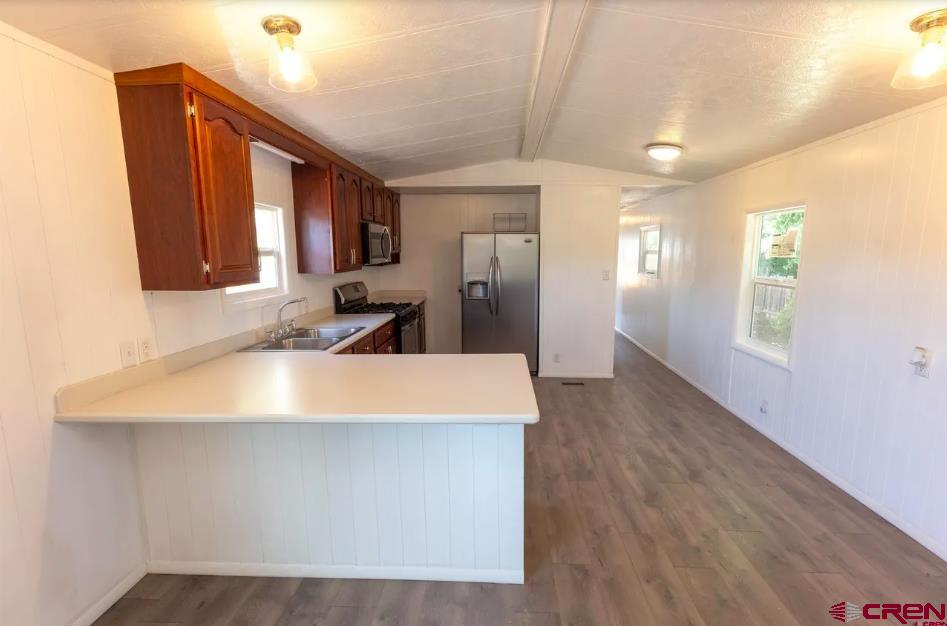 11 Rickey Place Monte Vista, CO 81144 - Photo 13 of 16 a large white kitchen with wooden floor