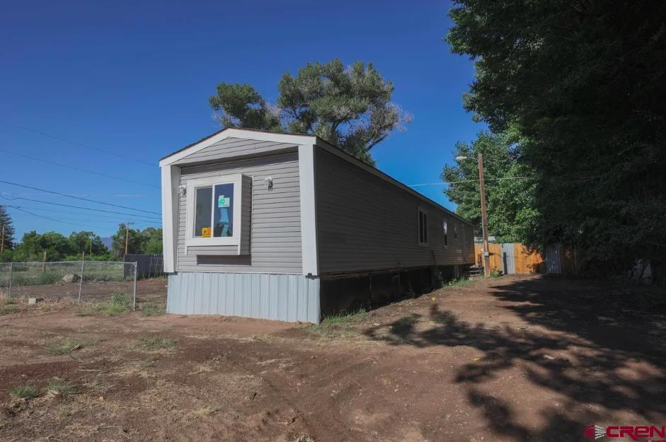 11 Rickey Place Monte Vista, CO 81144 - Photo 15 of 16 a front view of a house with a yard and garage