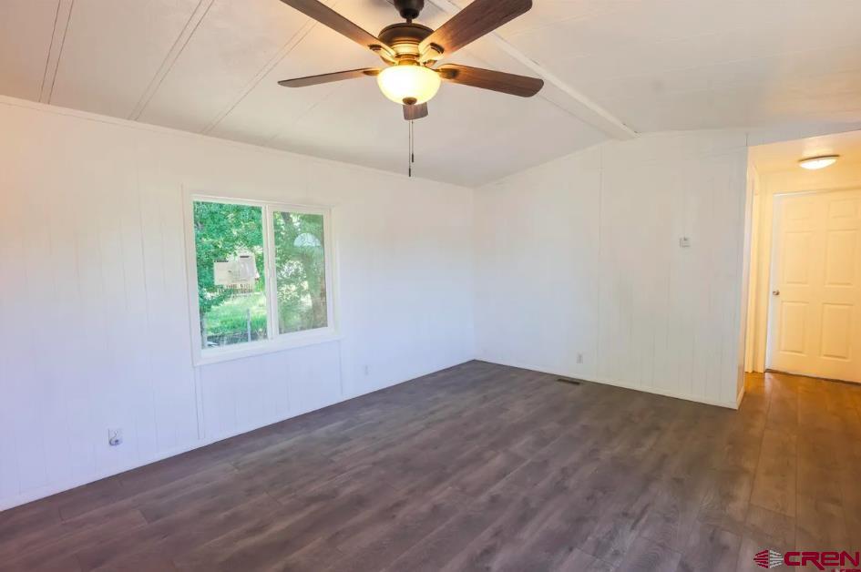 11 Rickey Place Monte Vista, CO 81144 - Photo 9 of 16 an empty room with wooden floor fan and windows