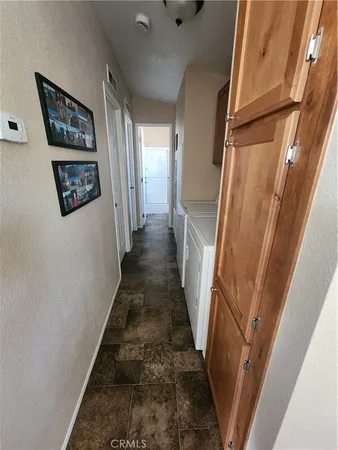 a view of a hallway with wooden floor and stairs