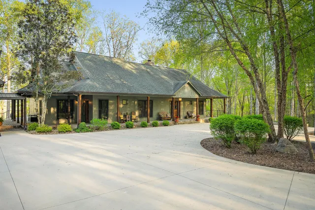 a backyard of a house with lots of green space and plants