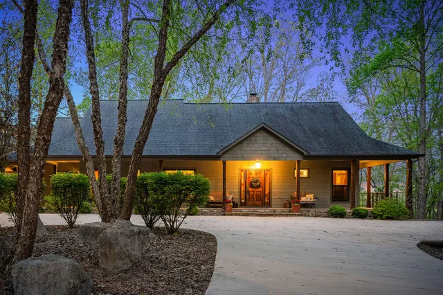 an aerial view of a house with a yard basket ball court and outdoor seating