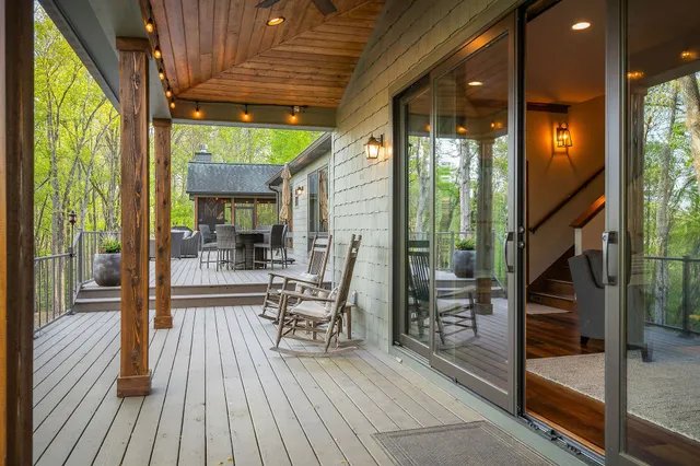 a dining room with furniture wooden floor and a chandelier
