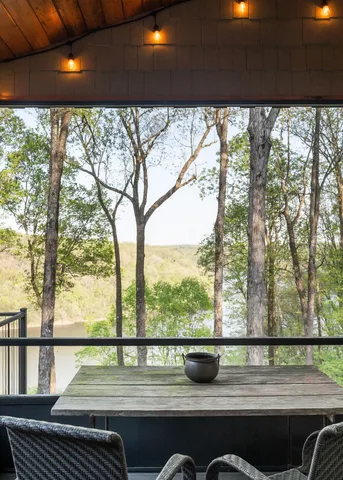 a bedroom with a bed and a flat tv screen next to a window