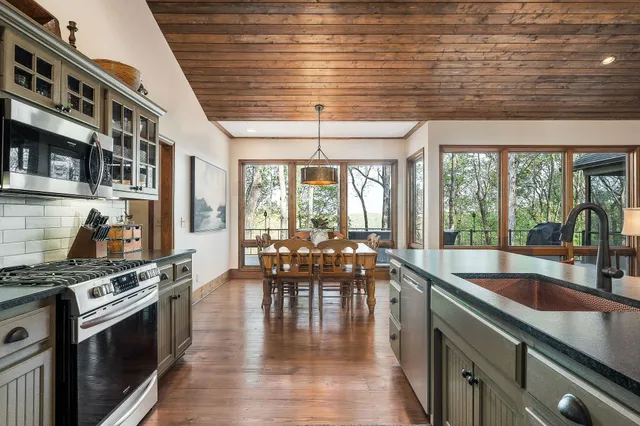 an aerial view of residential houses with outdoor space and lake view