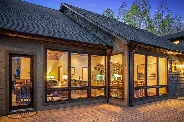 a front view of a house with a yard and potted plants