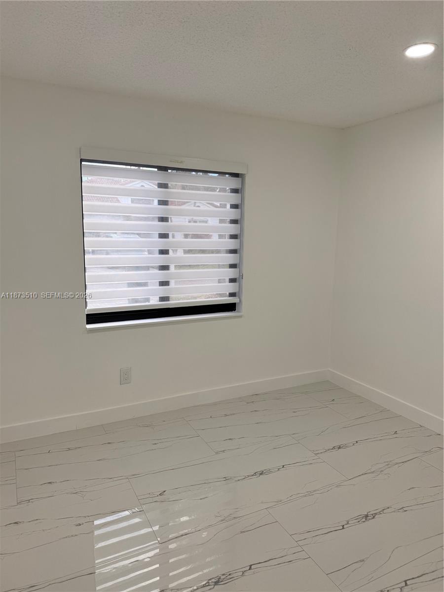 15921 Southwest 82nd Street Miami, FL 33193 - Photo 12 of 20 an empty room with a window