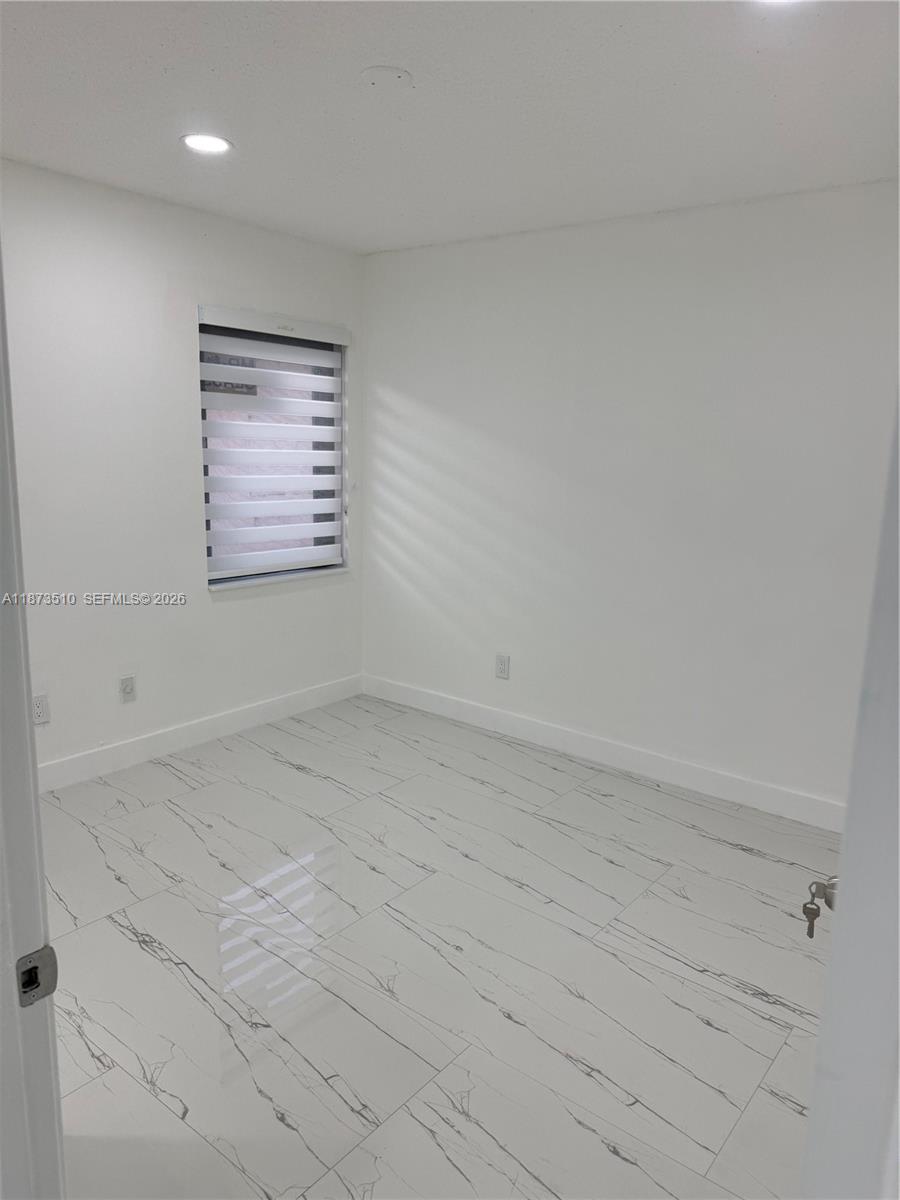 15921 Southwest 82nd Street Miami, FL 33193 - Photo 13 of 20 a view of an empty room and window